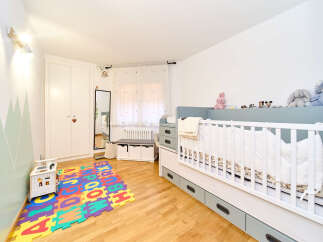 Adorable and well-designed baby's room features a modern crib with ample storage, a playful alphabet mat, and a calming color palette.
