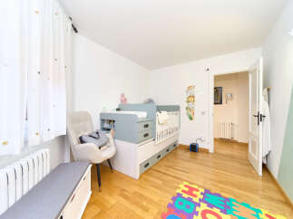 Delightful nursery with built-in crib and changing station, offering ample storage.