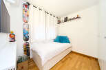 Cozy bedroom with built-in storage and hardwood floors.