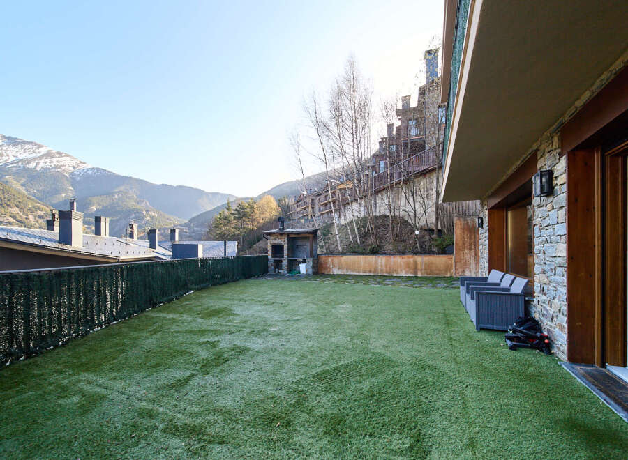 This stunning property boasts a private terrace with artificial turf, perfect for outdoor relaxation.