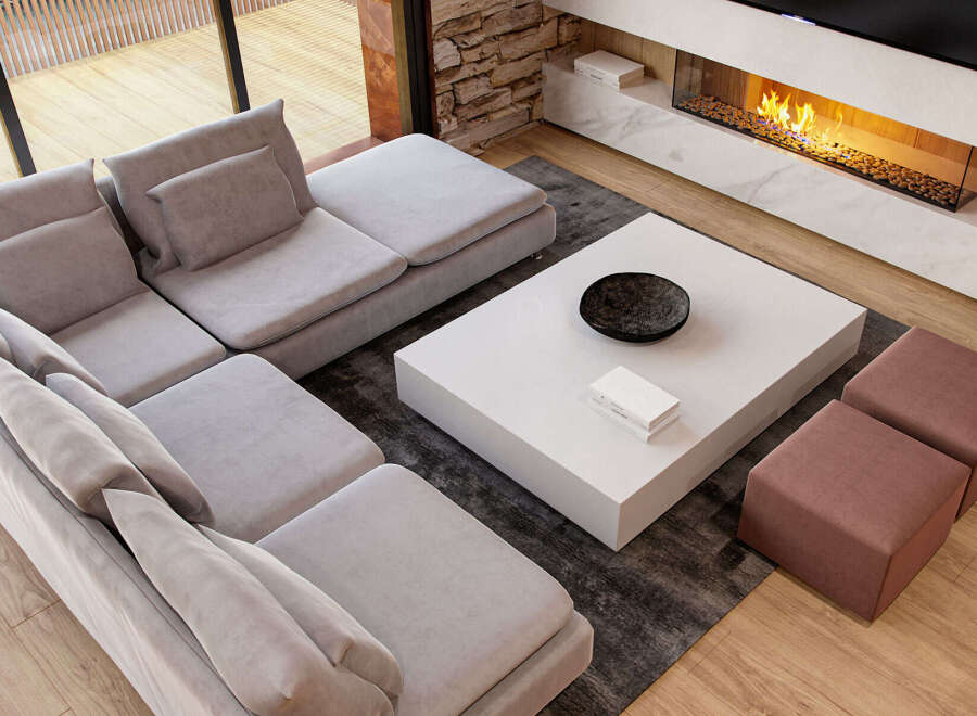 Modern living room with a spacious sectional sofa, a sleek white coffee table, and a stunning fireplace.