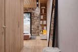 This stunning hallway boasts a modern design with a blend of natural wood and stone.