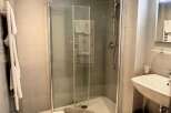 Discover a modern bathroom with a sleek glass shower enclosure.