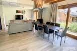 Discover a stunning property featuring a spacious living area with a modern dining set.
