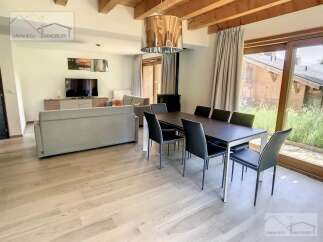 Discover a stunning property featuring a spacious living area with a modern dining set.