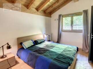 Discover a cozy bedroom with a wooden ceiling, creating a warm and inviting atmosphere.