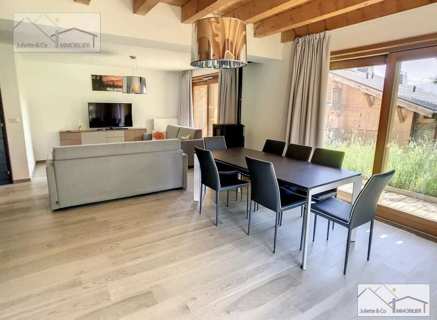 Discover a stunning property featuring a spacious living area with a modern dining set.