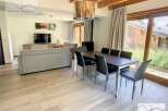 Discover a stunning property featuring a spacious living area with a modern dining set.
