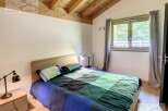 Discover a cozy bedroom with a wooden ceiling, creating a warm and inviting atmosphere.