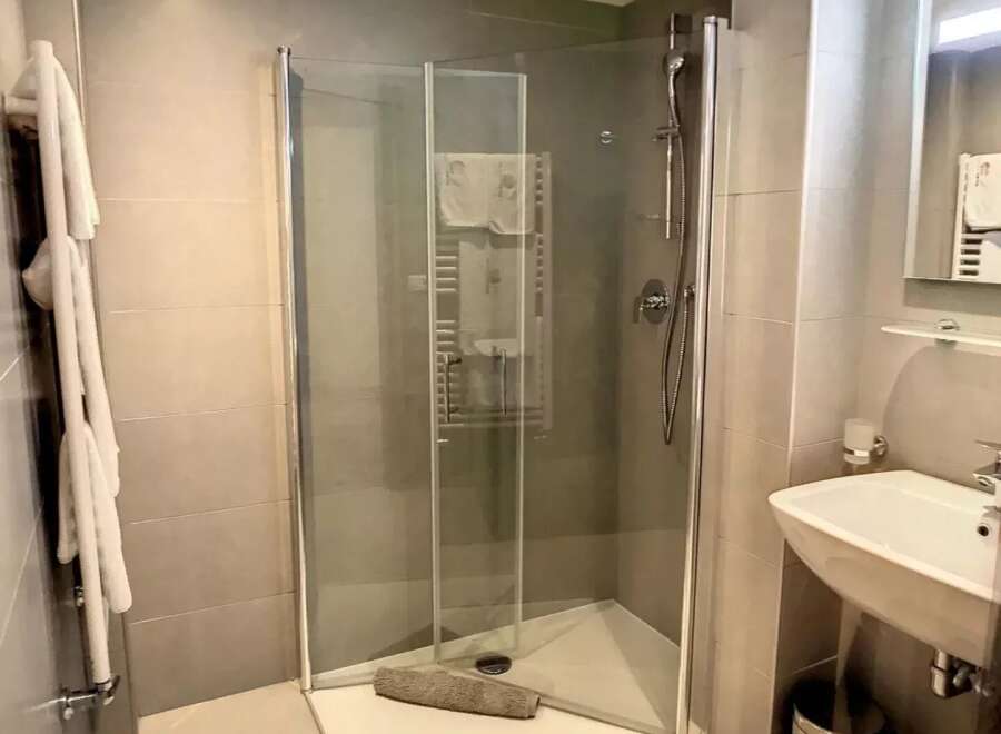 Discover a modern bathroom with a sleek glass shower enclosure.