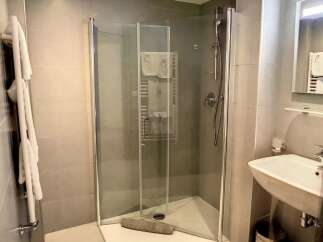Discover a modern bathroom with a sleek glass shower enclosure.