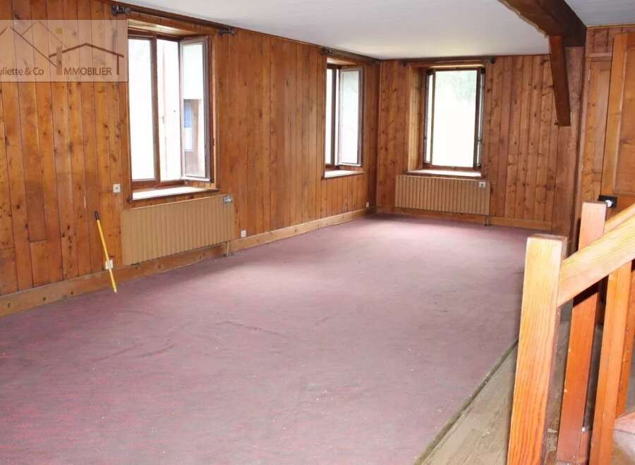 Discover the charm of this inviting property, featuring warm wooden paneling throughout.