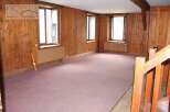 Discover the charm of this inviting property, featuring warm wooden paneling throughout.