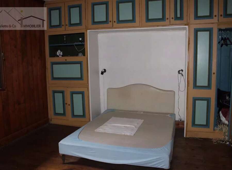 Discover this charming property featuring a cozy bedroom with built-in storage.