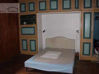Discover this charming property featuring a cozy bedroom with built-in storage.