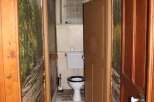 Explore this charming property featuring a unique hallway leading to a cozy bathroom.