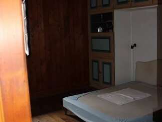 Discover this charming bedroom featuring a cozy bed and ample storage.