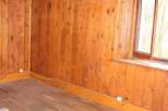 Discover the charm of this cozy room, featuring beautiful wooden walls and flooring that exude warmth and character.