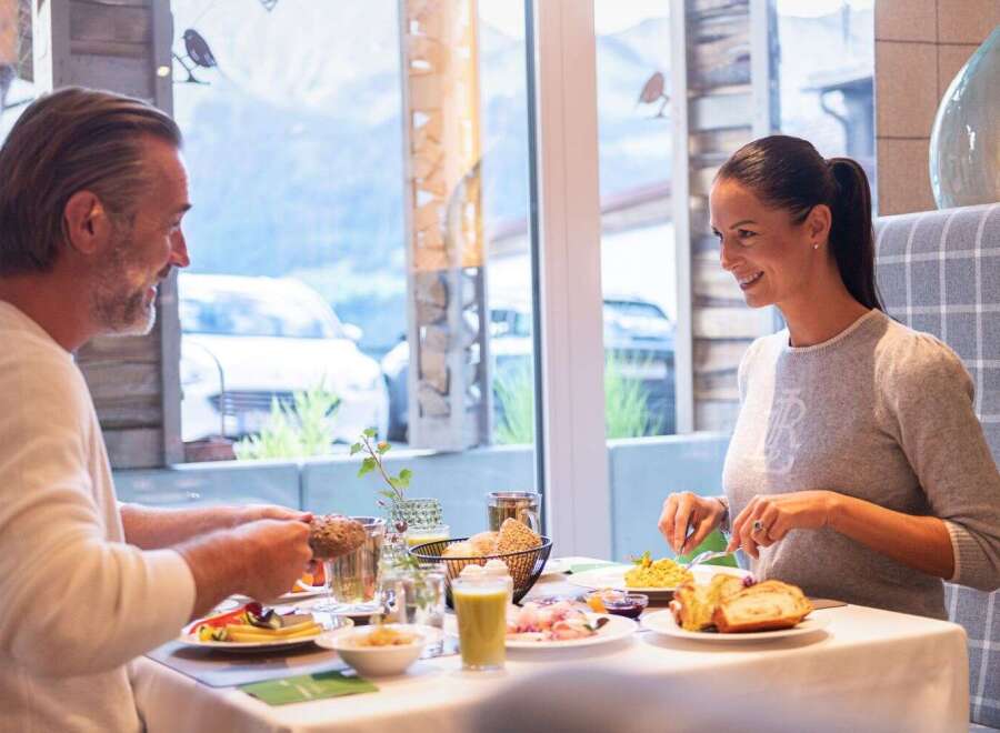Enjoy a delightful breakfast at our hotel, featuring a bright and airy dining area with large windows offering scenic views.