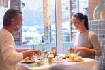 Enjoy a delightful breakfast at our hotel, featuring a bright and airy dining area with large windows offering scenic views.