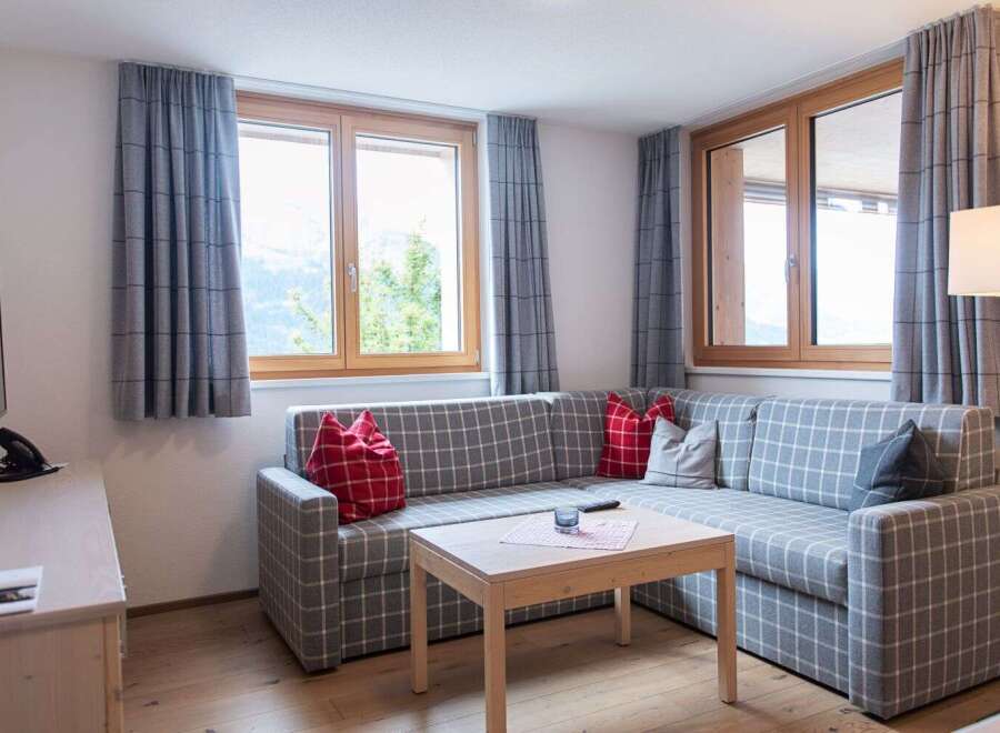 Cozy living room with a comfortable L-shaped sofa, perfect for relaxing after a day of exploring the mountains.