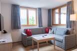 Cozy living room with a comfortable L-shaped sofa, perfect for relaxing after a day of exploring the mountains.