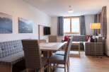 This cozy apartment boasts a spacious living area with a comfortable L-shaped sofa, perfect for relaxing after a day of adventure.