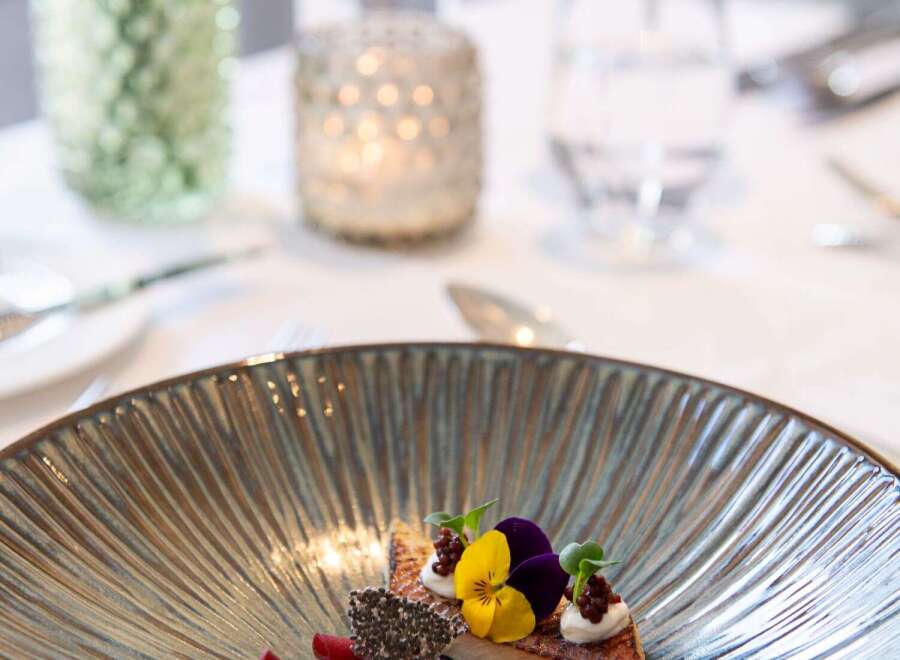 A delectable culinary creation is artfully presented on a sophisticated plate, showcasing a harmonious blend of colors and textures.