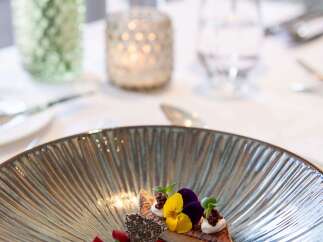 A delectable culinary creation is artfully presented on a sophisticated plate, showcasing a harmonious blend of colors and textures.