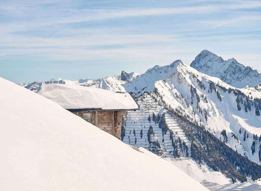 Nestled in a breathtaking snowy mountain range, this charming wooden cabin offers unparalleled seclusion and stunning views.