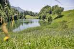 Discover serenity at this idyllic lakefront property nestled amidst lush greenery and majestic mountains.