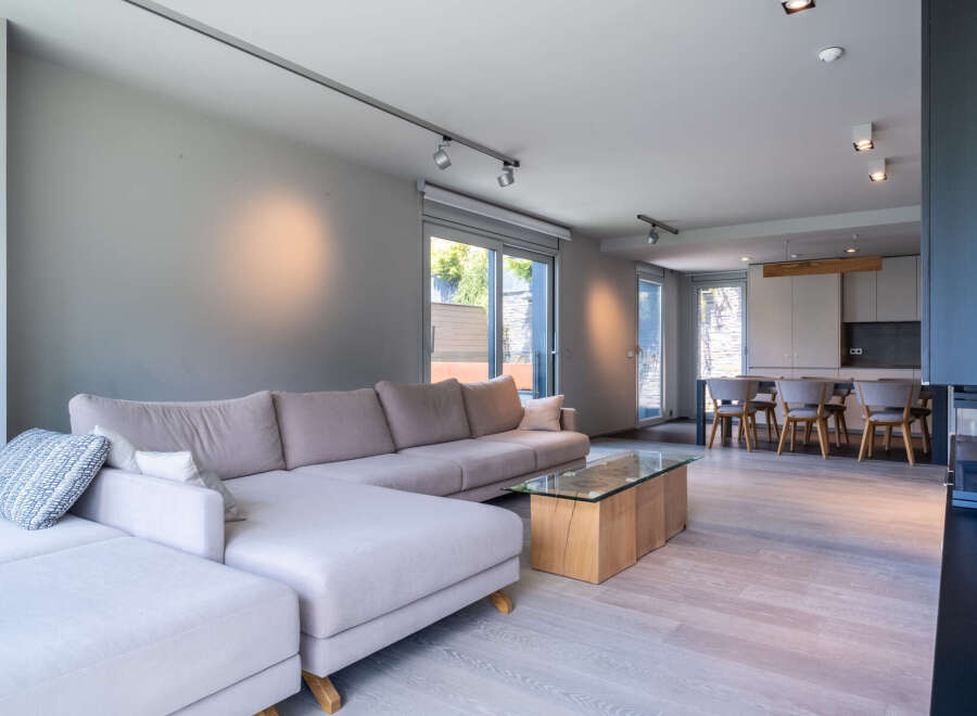 This stunning property boasts an open-plan living area with a spacious L-shaped sofa, perfect for relaxation and entertaining.