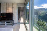 Modern living space with floor-to-ceiling windows offering breathtaking mountain views.