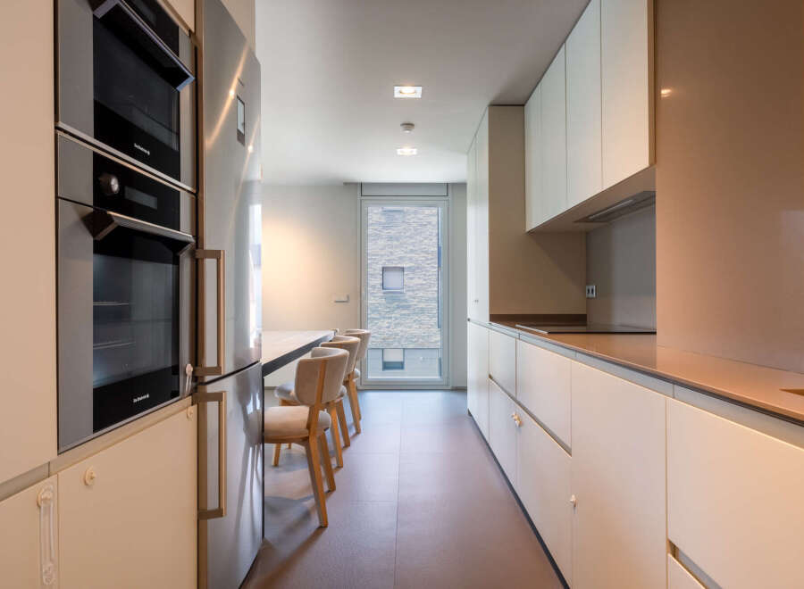 Modern kitchen with built-in appliances and sleek cabinetry.