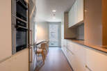 Modern kitchen with built-in appliances and sleek cabinetry.