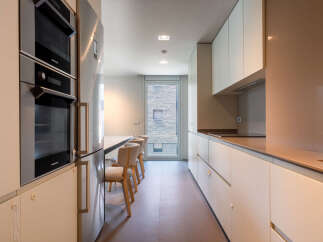 Modern kitchen with built-in appliances and sleek cabinetry.