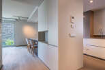 Modern apartment boasts sleek built-in cabinetry and light oak flooring.