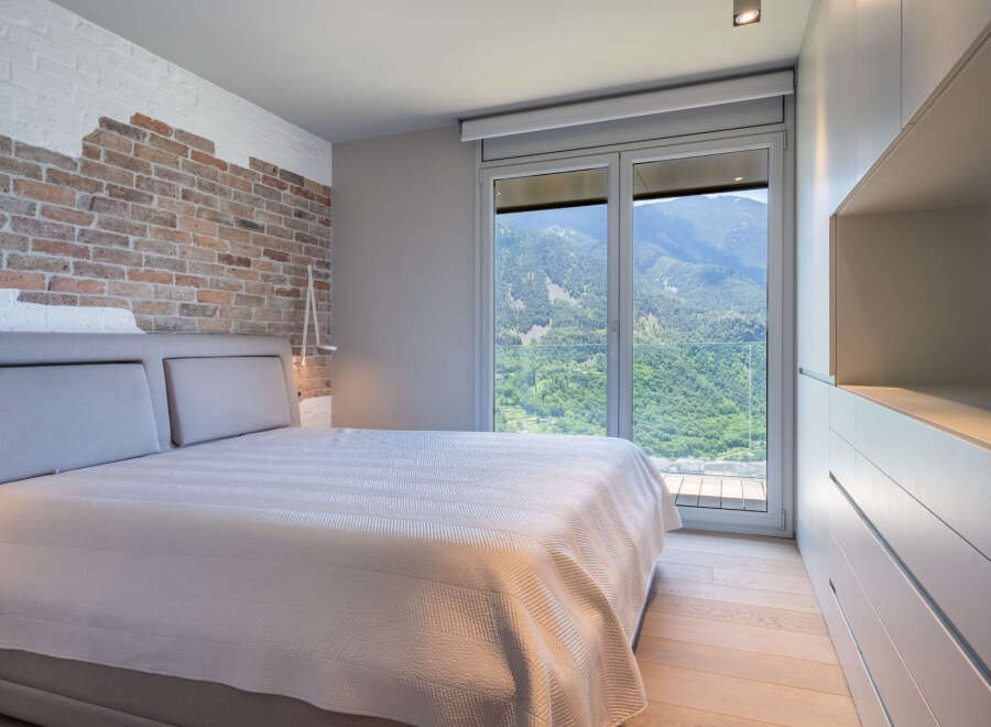 Wake up to breathtaking mountain views from this luxurious bedroom.