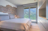 Wake up to breathtaking mountain views from this luxurious bedroom.