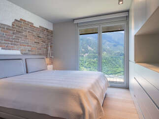 Wake up to breathtaking mountain views from this luxurious bedroom.