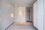 This stunning bedroom boasts built-in wardrobes and light oak flooring, creating a bright and airy atmosphere.
