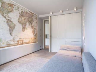 This stunning property boasts a spacious room with built-in wardrobes and a comfortable daybed, perfect for relaxation.