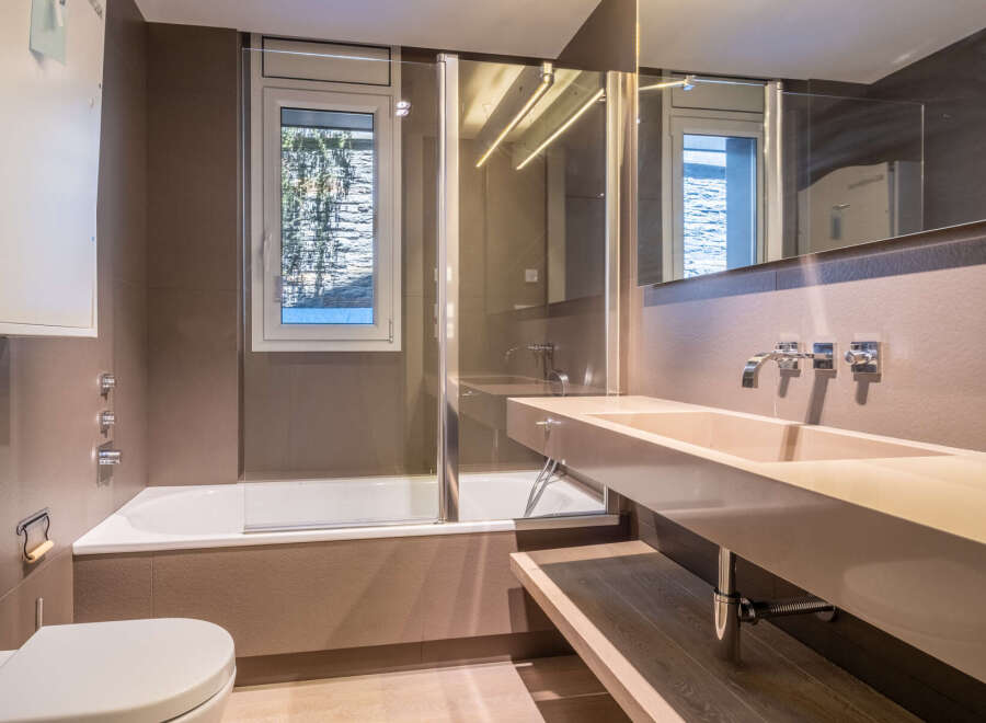 This stunning bathroom boasts a modern design with sleek, neutral tones and high-end fixtures.