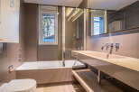 This stunning bathroom boasts a modern design with sleek, neutral tones and high-end fixtures.