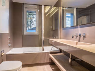This stunning bathroom boasts a modern design with sleek, neutral tones and high-end fixtures.