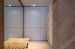 Modern hallway with built-in storage and wooden slatted bench.