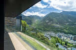Luxury mountain view balcony with glass railings and composite decking.