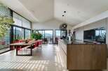 Stunning open-plan living space with floor-to-ceiling windows offering breathtaking views.
