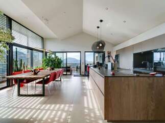 Stunning open-plan living space with floor-to-ceiling windows offering breathtaking views.