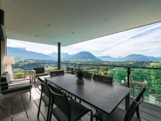This stunning property boasts breathtaking panoramic mountain views from its expansive balcony.